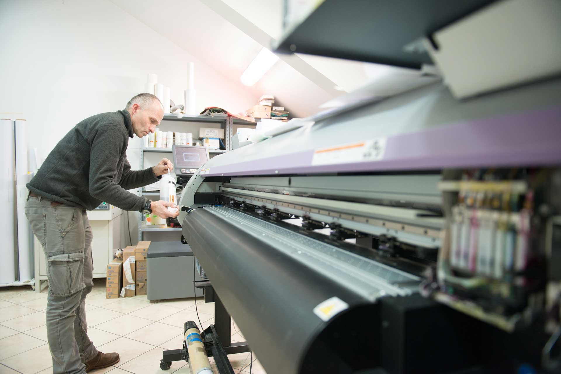 technician_swabbing_clean_large_format_printer