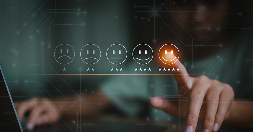 finger pointing at the image of a customer service scale portrayed by a series of line drawings showing emotions