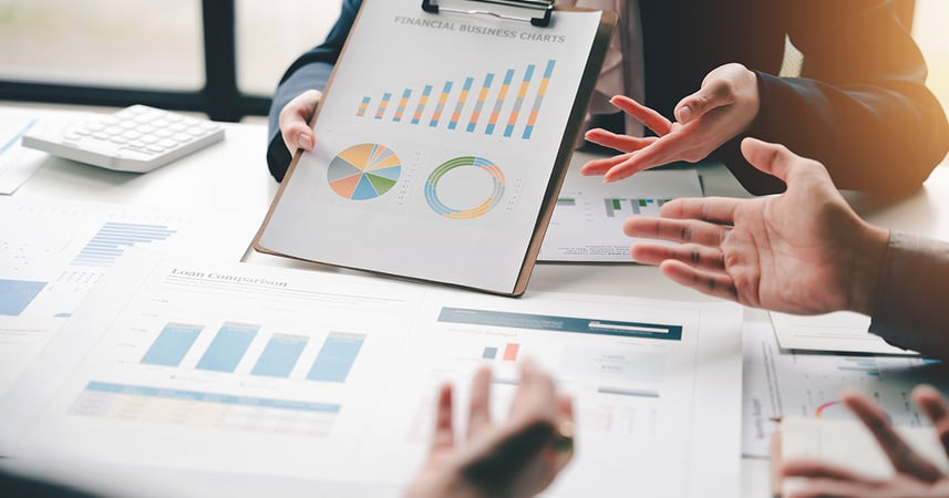 employees discussing graphs and charts 