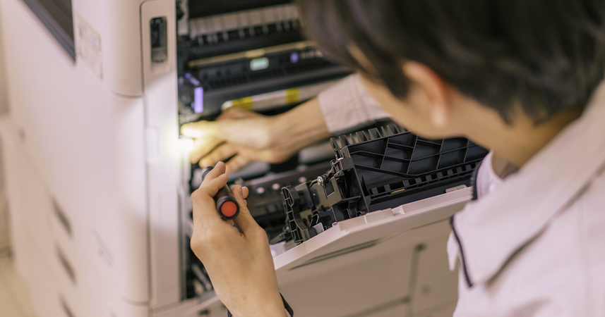 man fixing an office printer