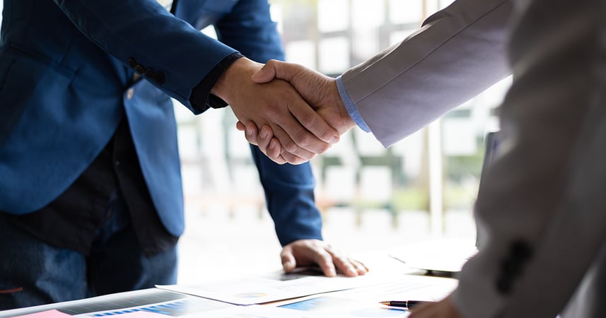 a handshake between two businessmen