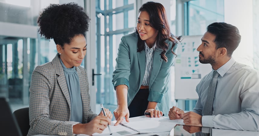 Workplace employees around a conference room table having a discussion