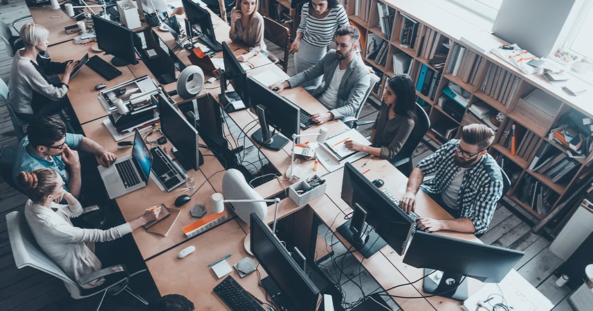 employees working in an open concept workspace