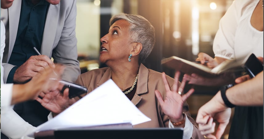 Woman in office overwhelmed with questions from co-workers