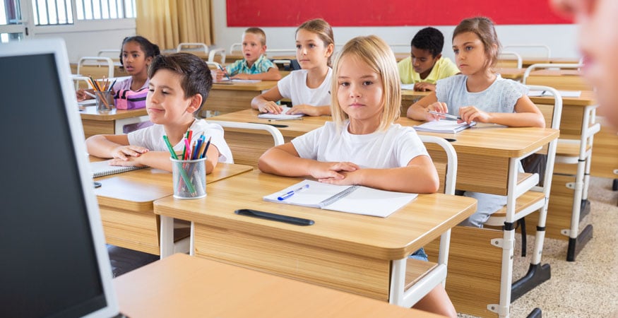 kids sitting at school desks