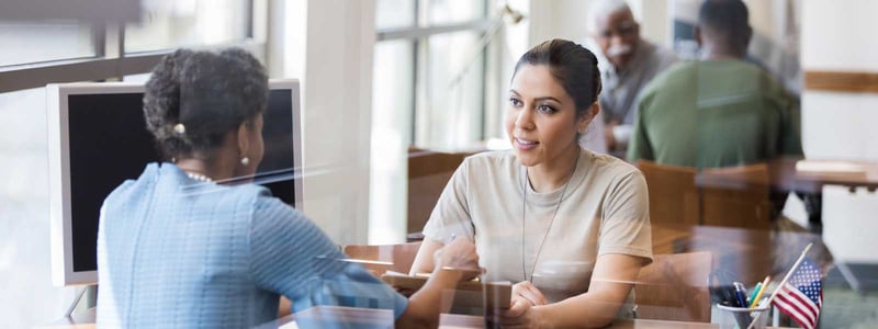 woman_sitting_at_banker_desk