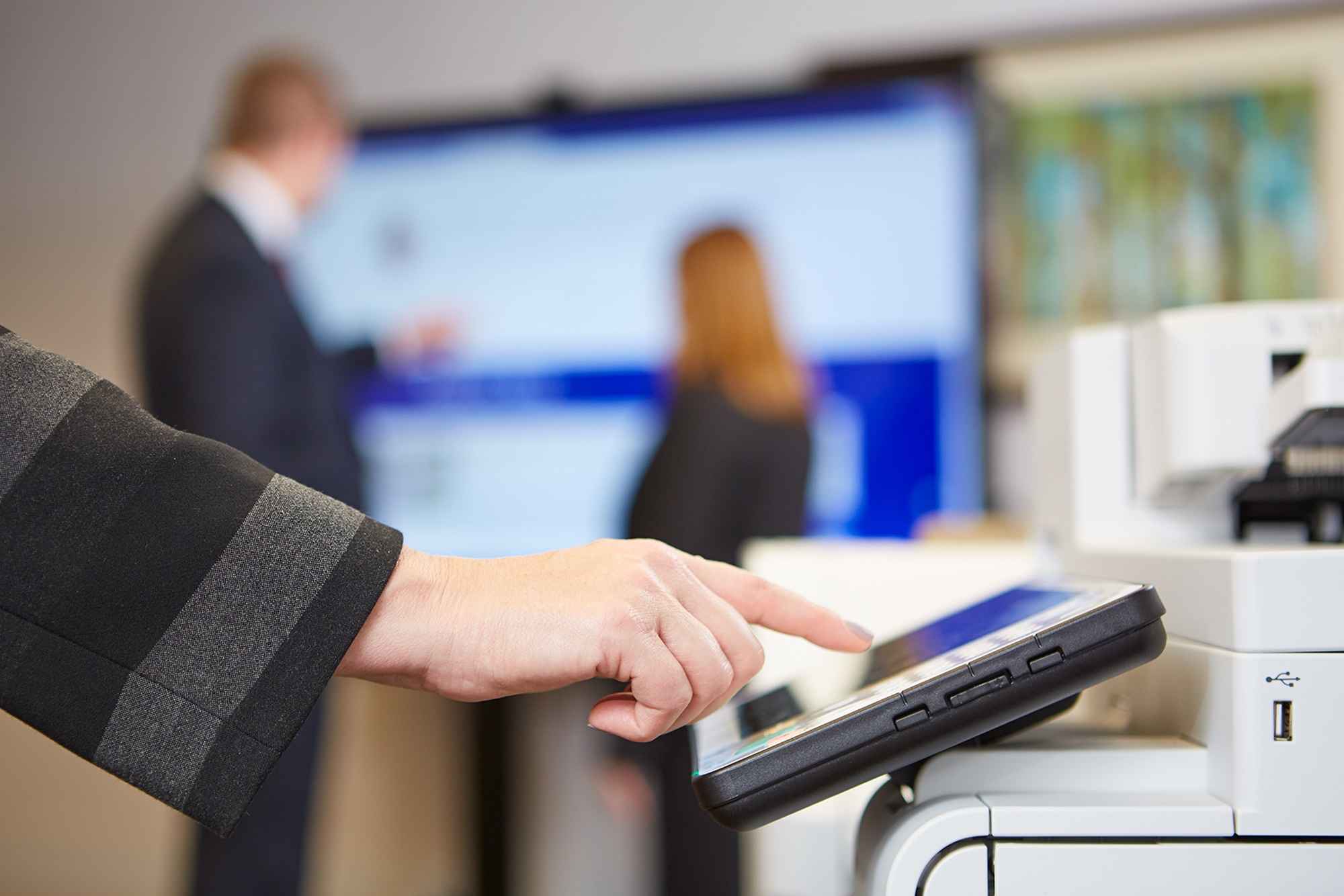 hand-interacting-with-touch-screen-on-printer