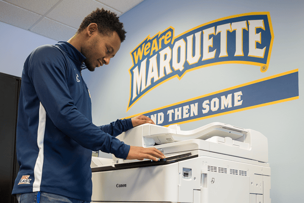 Marquette Athlete Using Printer