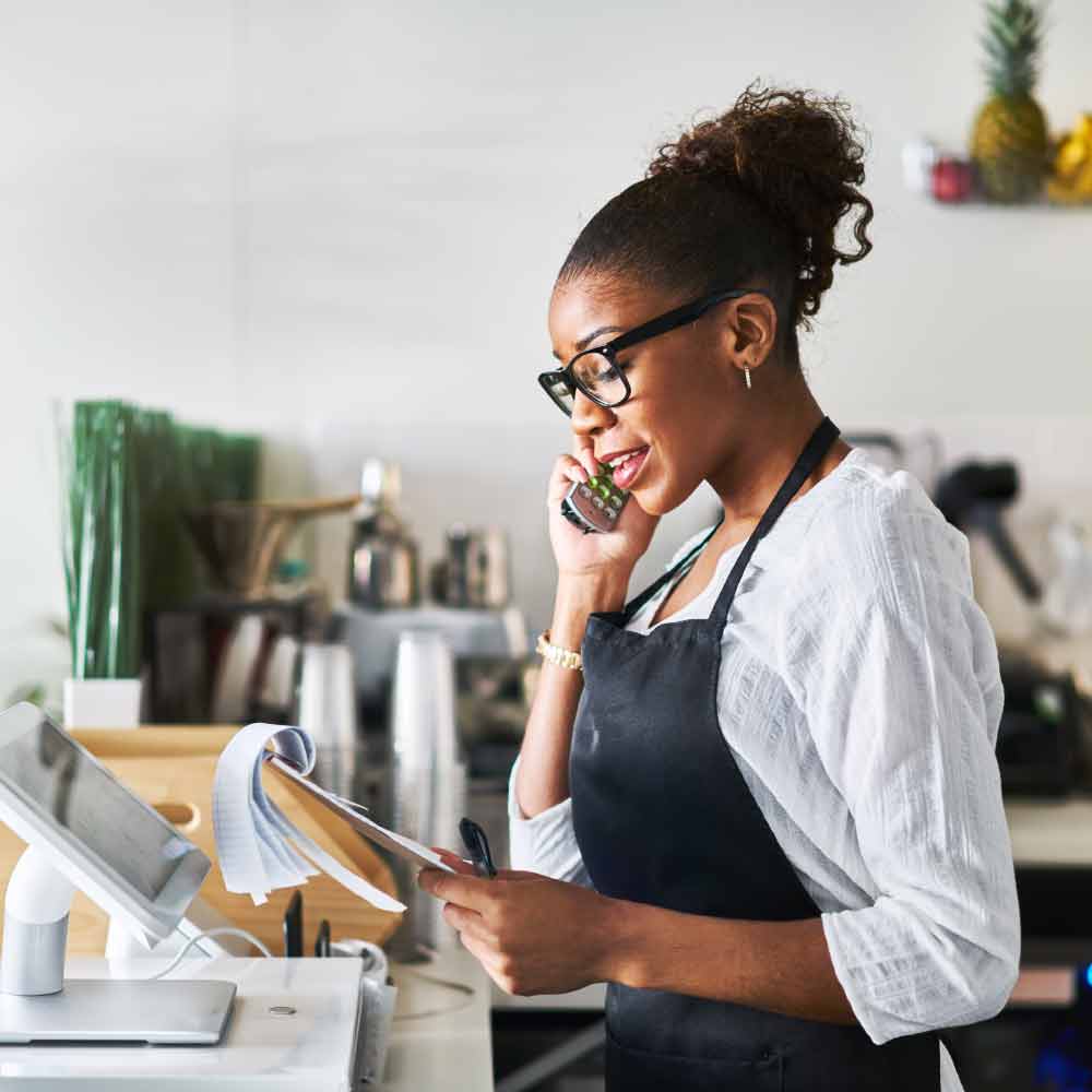 woman_at_counter_taking_order_over_phone