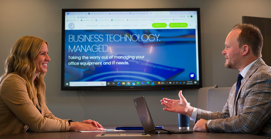 people talking in a meeting room with an interactive whiteboard