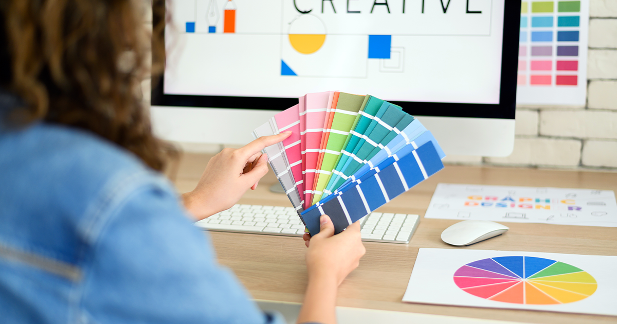 Designer looking at a Pantone swatch color book