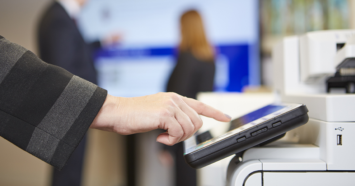 hand using touchpad on office copy machine