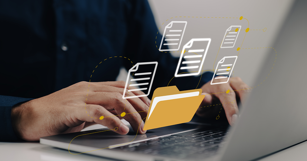 hands on laptop keyboard with digital image outlines of documents and file folders across the screen. 