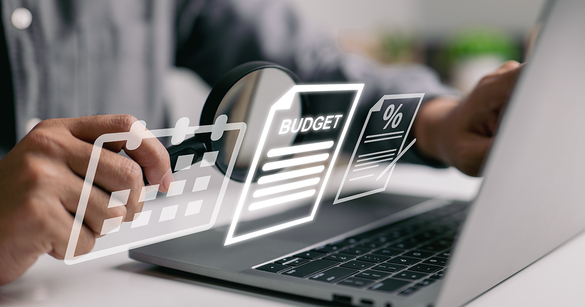 hands typing at a keyboard working on setting an office budget
