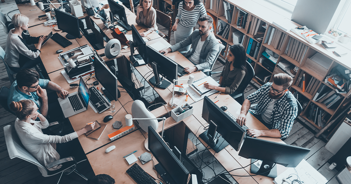employees working in an open concept workspace