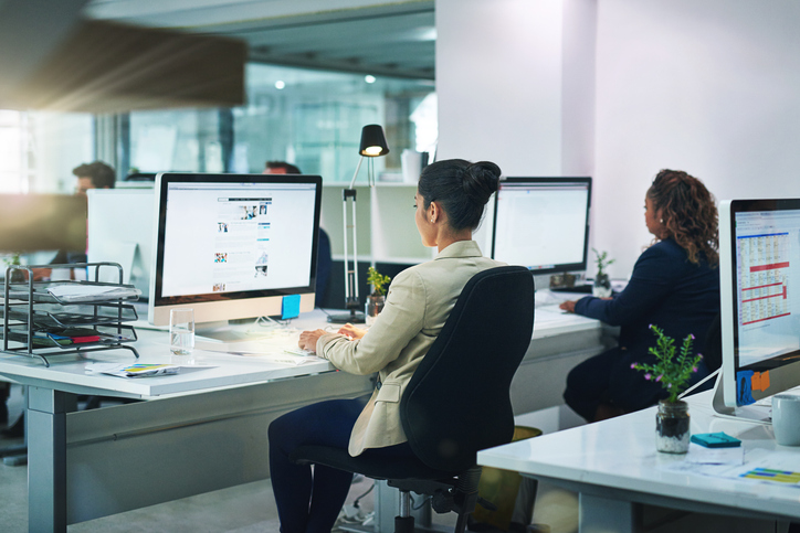 women browsing the web at work in an office