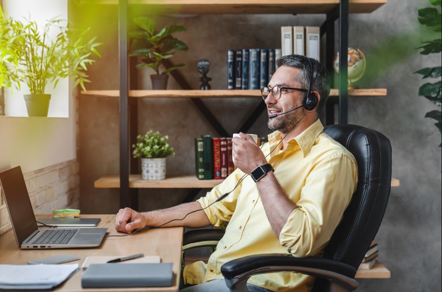 man sitting in home office at computer